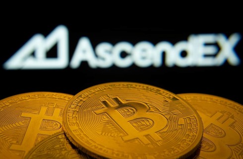 Dhaka, Bangladesh- 02 June 2025: Close-up of Bitcoin coins with the AscendEX logo visible on a