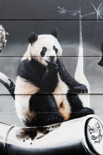 Happy panda bear sitting on bamboo, graffiti, Duisburg, North Rhine-Westphalia, Germany