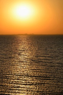 Sunset over the North Sea, on the horizon the contours of the island of Juist, Norddeich, Lower