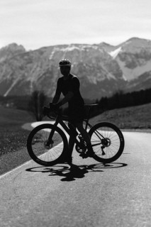 Road bike rider in spring near Halblech in the Allgäu in front of a picturesque backdrop of the