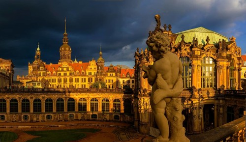 Glockenspiel pavilion of the Zwinger and Residenzschloss in the evening light in front of a dark