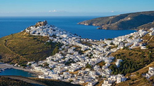 Whitewashed settlement stretches along a hill overlooking the blue Mediterranean, Querini Castle,
