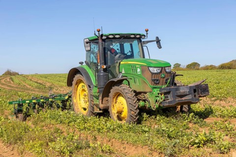 John Deere 6155R tractor equipped with a Garford inter-row hoe, hoeing field of parsnips,
