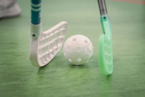 Two sticks and a floorball held on the field, Foolball, Calw, Germany