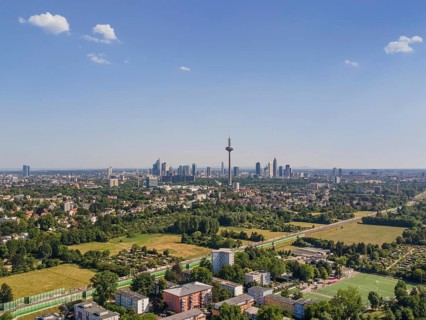 Just a few clouds drift across the Frankfurt banking skyline against a brilliant blue sky, whilst