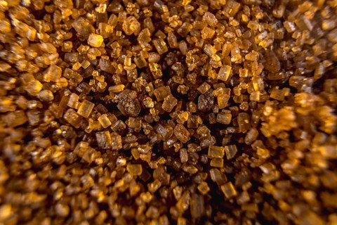 Detail of texture of beautiful brown sugar grains, macro photography