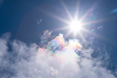 Brilliant sun over iridescent colorful clouds in the sky, Ternitz, Lower Austria, Austria