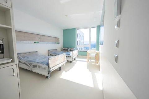 Bright hospital room with beds and large window in modern style, patient room cash desk in the new