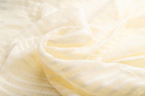 Fragment of white linen tissue. Side view, natural textile background and texture. wave concept,