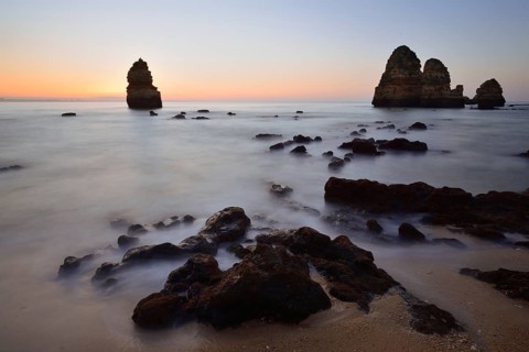 Beach and rock formations at dawn, Praia do Camilo, Lagos, Algarve, Portugal