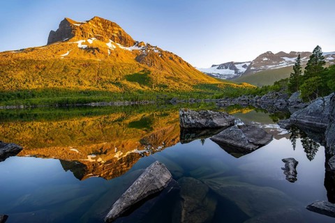 Picturesque mountain landscape in the Innerdalen high valley, mountain peaks reflected in Lake
