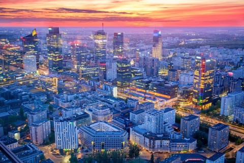 Broad view across the Warsaw skyline in Poland with skyscrapers, city lights, glass high-rises,