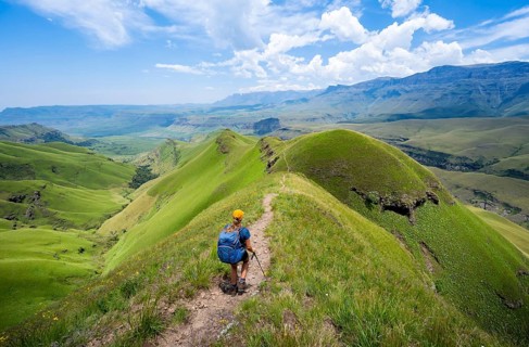 Female hiker on the hiking trail to Cathedral Peak, Green Mountains and Hills, Drakensberg