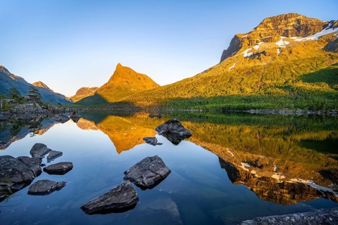 Picturesque mountain landscape with peaks in the Innerdalen high valley, mountain peaks reflected