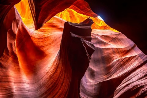Antelope canyon slot canyon interior showcasing vibrant orange and red light illuminating the