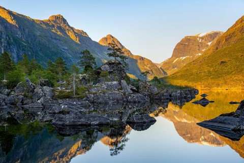 Picturesque mountain landscape with Gi in the Innerdalen high valley, mountain peaks reflected in