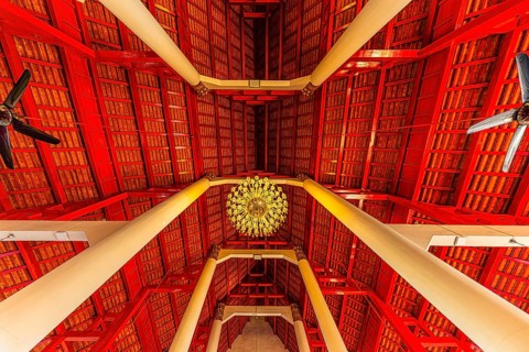 Gilded Buddha statue in a public prayer hall in the Wat Phra Singh Buddhist temple complex, Chiang