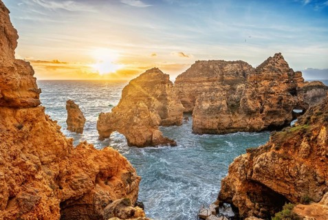 Ponte da Piedade in Lagos, Algarve, Portugal, at sunrise with Atlantic ocean, sea stacks, limestone