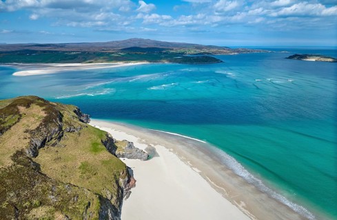 Aerial photo of a bay with golden sand beach at the scottish atlantic coast near Coldbackie,