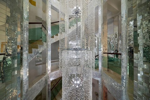 Huge lamp decorated with glass beads in the stairwell, main chedi (Phra That), Buddhist temple