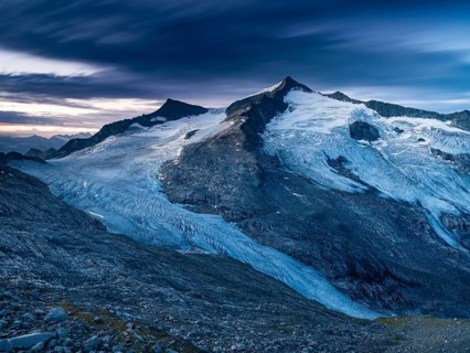 Glaciated summit of Grossvenediger, at dawn, on the Venedigerkees Traces of light from