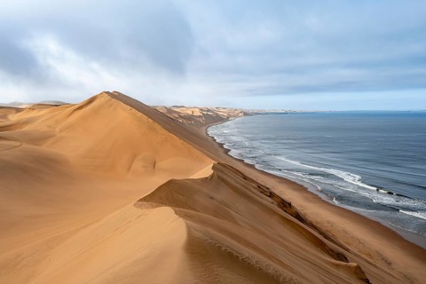 Sand dunes and sea in the morning, Atlantic coast and sandy desert with sea of dunes, Sandwich