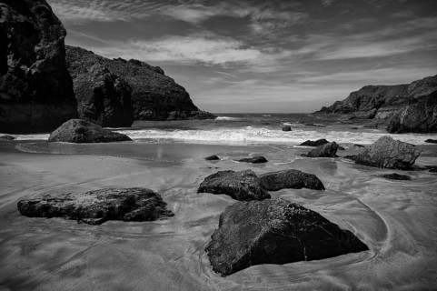 Wet rocks at low tide in sand, coastal landscape, coast, rock formations, sandy beach, beach, sea,