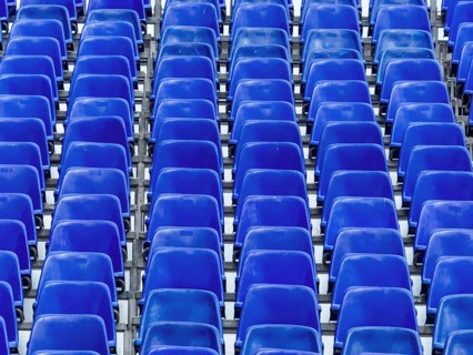 Football stadium, stand with blue chairs, symbolic photo for background, events, infrastructure,