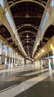 Long, light-filled corridor with decorative arches and large windows, Maxim Gorky Kollonade,