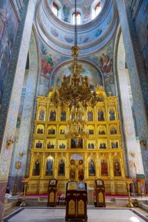 Beautiful interior of an Orthodox church with golden iconostasis and frescoes, Capriana monastery,