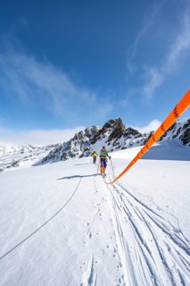 Ski tourer with rope, rope team on the Vadret da Porchabella glacier on the ascent to the summit of