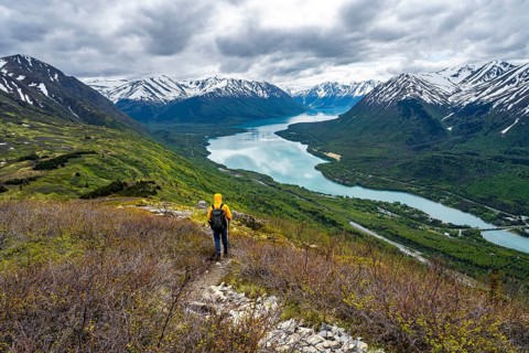 Climbers on a hiking trail on Slaughter Ridge, views of snowy mountains in spring and turquoise