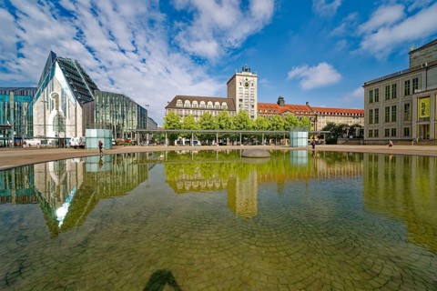Morning atmosphere, Leipzig Augustusplatz with university and Kroch skyscraper, reflection, water