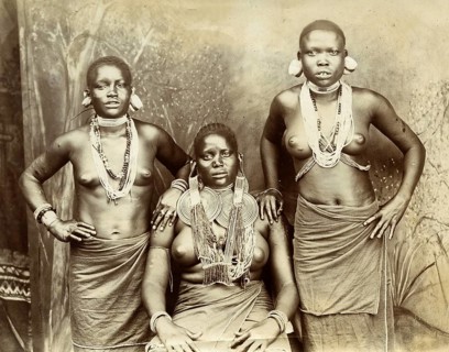 Africa, Zulu, South Africa, Three woman in traditional clothing and eye-catching jewelry pose for a