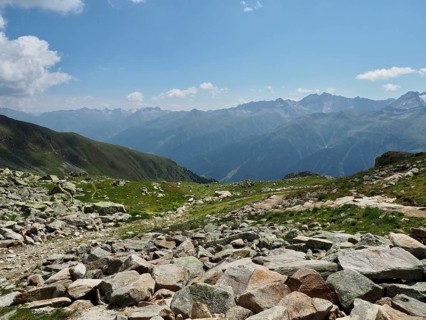 Rough, rocky terrain with a wide view over the Alps, blue sky with clouds, Bellwald, Goms, Canton