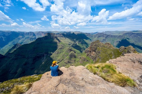 Female mountaineer at the summit of Cathedral Peak or Cathedralpiek or Mponjwana, Drakensberg,