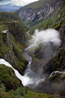 Majestic waterfall in a deep gorge with lush green landscape, Voringsfossen, with 165m drop, above