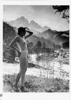 Nude photography, grace, beauty, woman standing in front of an impressive mountain backdrop and