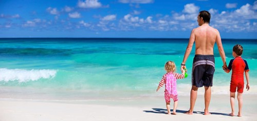 Father and two children running on beach, vacation, Seychelles, La Digue, La Digue, Indian Ocean,