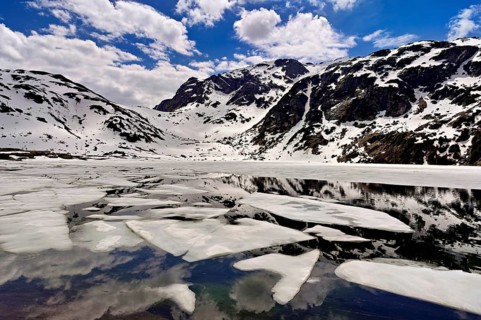 Ice floes float in the half-frozen Upper Murgsee, Murgtal, Canton of St. Gallen, Switzerland