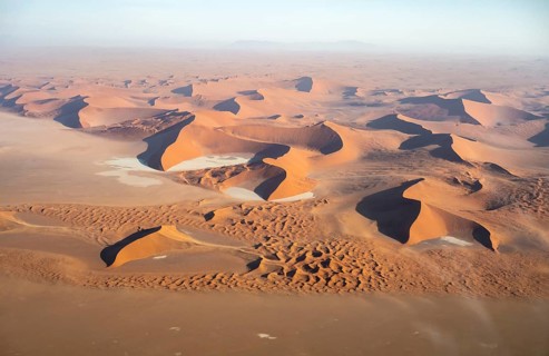 Aerial view of salt pans and red sand dunes of the Namib Desert, Namib Naukluft Park, Namibia