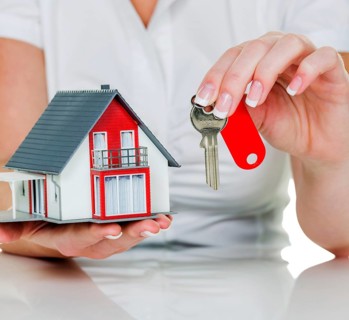 A real estate agent with a house and a key rental and house sale by real estate agent, apartment