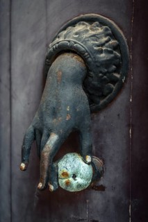 Old French door knocker with hand and apple on front door in Pèrigueux, Dordogne, France