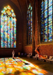 Sky swing in the town church of Our Dear Women, installation by Mario Haunhorst with stained glass