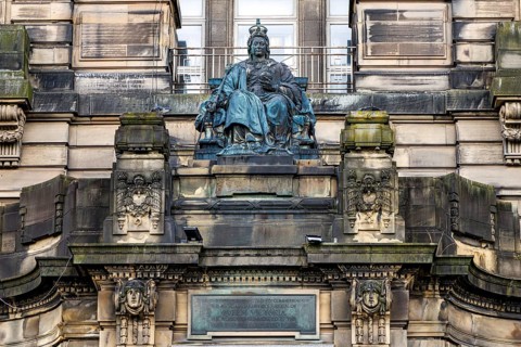 Enthroned bronze Queen Victoria statue crowns the Glasgow Royal Infirmary Jubilee block entrance,