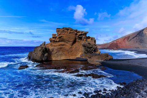 Lanzarote, Canary Islands, Spain, Europe, El Golfo, Majestic rock formation by the sea with foaming