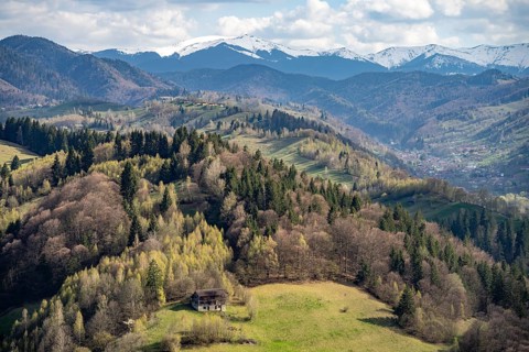 The snow-capped Bucegi Mountains and the countryside near Bran or Törzburg, Transylvania, Romania