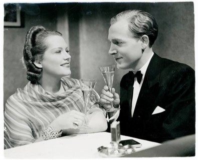 Movie scene, German movie, actor undetected, elegant couple in evening wear toast with champagne