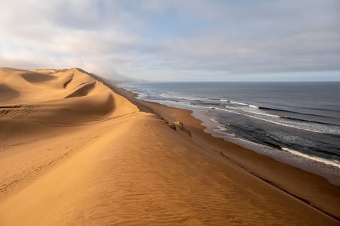Sand dunes and sea with coastal fog in the morning, Atlantic coast and sandy desert with sea of