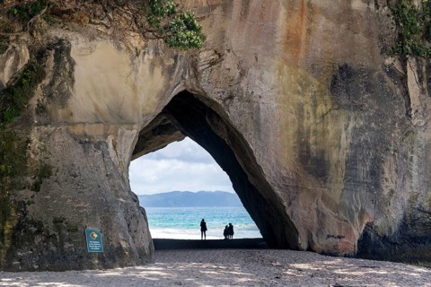 The iconic Mautohe Cathedral Cove, a gigantic arched cavern that passes through a rock headland to